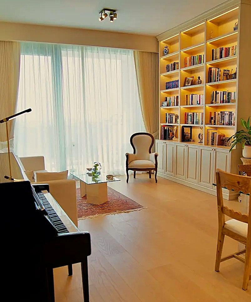 Jumeirah Piano Studio — the salon with Kingsburg piano, library, Isabeline armchair and window overlooking Safa Park